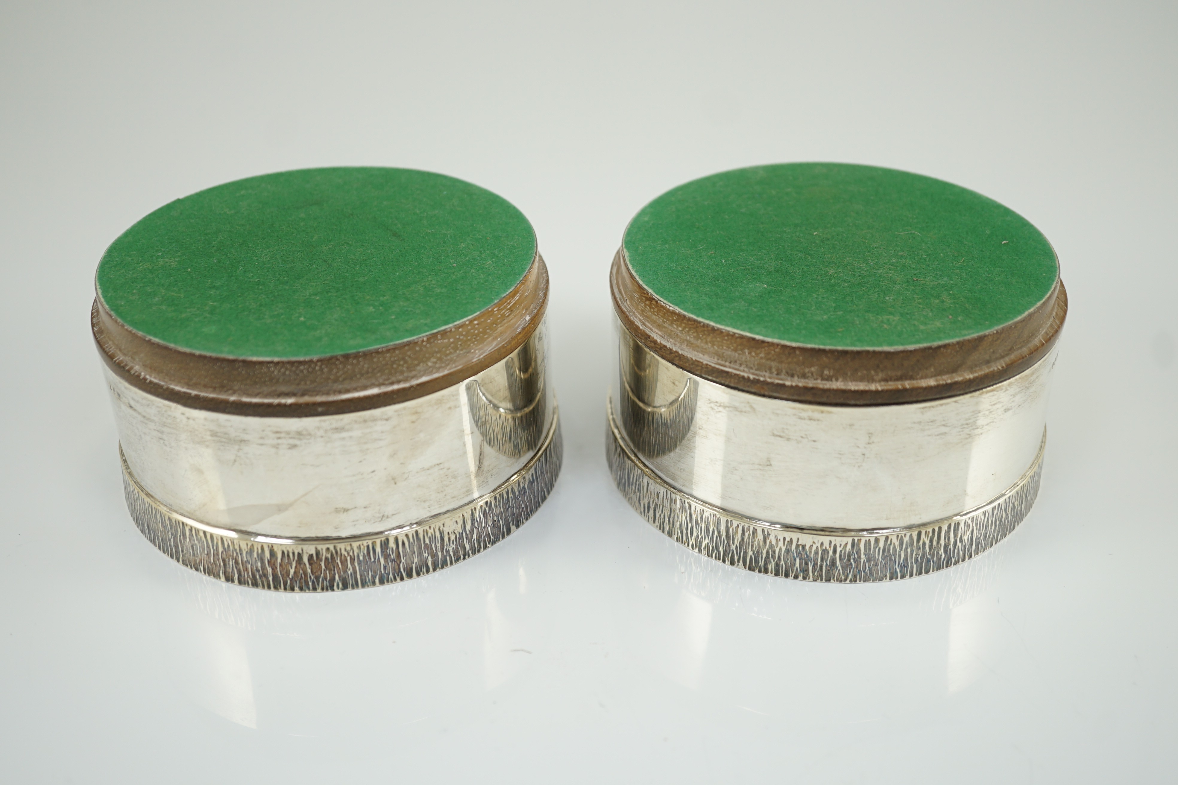 A pair of Elizabeth II silver wine coasters, by Graham Watling